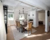 Dining space with hardwood / wood-style floors, beamed ceiling, coffered ceiling, and ornamental molding