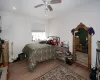 Bedroom with ceiling fan and hardwood / wood-style floors