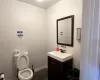 Bathroom featuring tile patterned flooring, vanity, and toilet