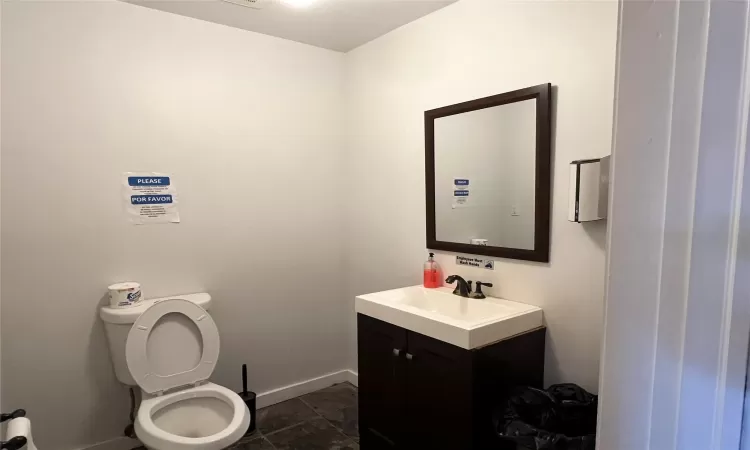 Bathroom featuring tile patterned flooring, vanity, and toilet