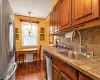 Kitchen with pendant lighting, sink, dark hardwood / wood-style floors, tasteful backsplash, and stainless steel appliances