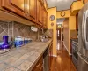 Home office featuring wood-type flooring, an inviting chandelier, an AC wall unit, and ornamental molding