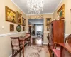 Dining space featuring an inviting chandelier, ornamental molding, and hardwood / wood-style flooring