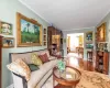 Living room featuring hardwood / wood-style floors and crown molding