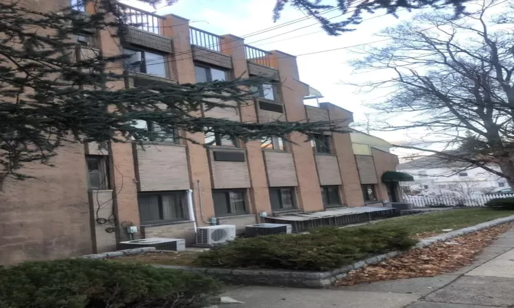 View of building exterior featuring central AC unit and ac unit