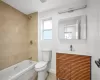 Full bathroom featuring tile patterned floors, toilet, vanity, and tiled shower / bath