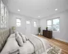 Bedroom featuring baseboard heating and light hardwood / wood-style flooring