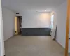 Unfurnished room featuring radiator heating unit and light colored carpet