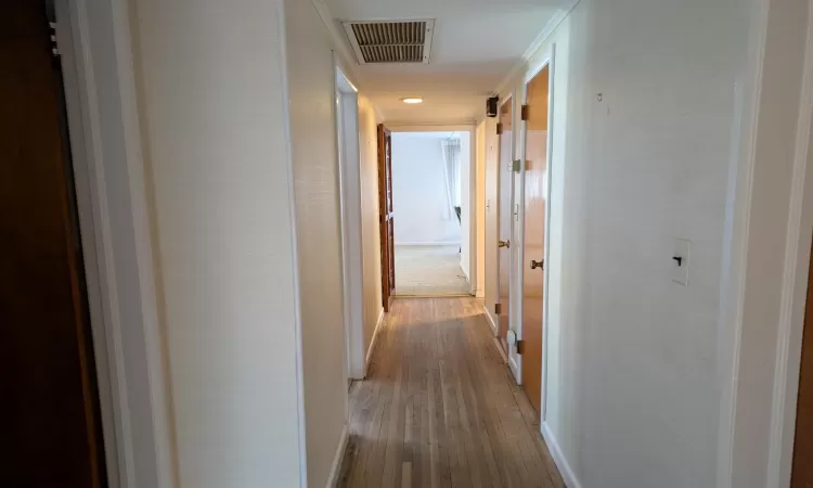 Hallway with hardwood / wood-style flooring