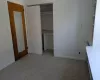 Unfurnished bedroom featuring a closet and light colored carpet