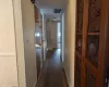 Hallway with dark hardwood / wood-style floors