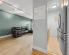 Kitchen featuring light brown cabinetry, light hardwood / wood-style flooring, stainless steel appliances, and track lighting