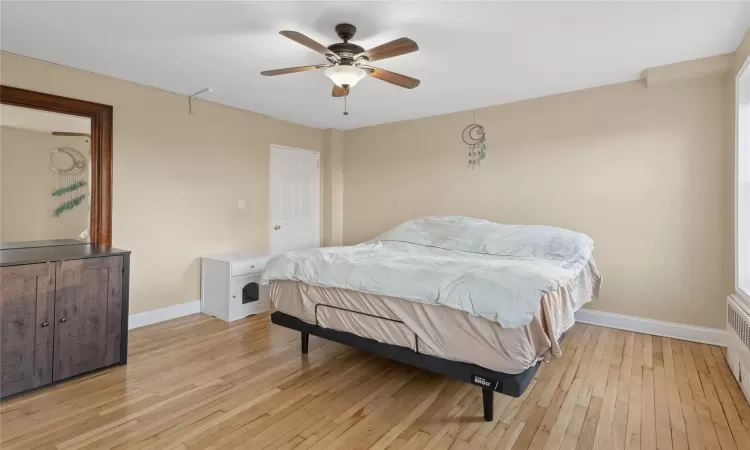 Bedroom featuring light hardwood / wood-style floors and ceiling fan