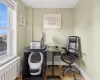 Home office featuring radiator, light wood-type flooring, and a wealth of natural light