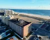 Aerial view featuring a water view and a beach view