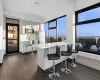 Kitchen with gray cabinetry, stainless steel appliances, tasteful backsplash, kitchen peninsula, and a breakfast bar area