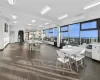 Dining area with a water view, dark wood-type flooring, and a wall mounted air conditioner