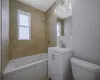 Full bathroom with vanity, tiled shower / bath, and toilet