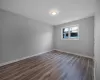 Unfurnished room featuring dark hardwood / wood-style flooring