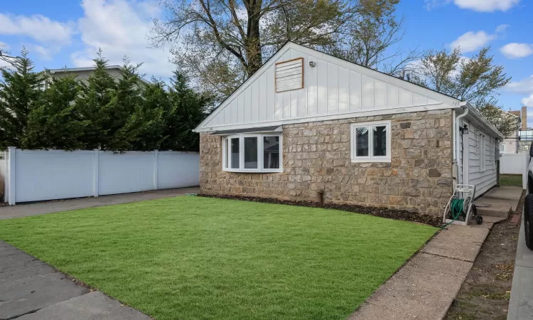 View of property exterior with a lawn