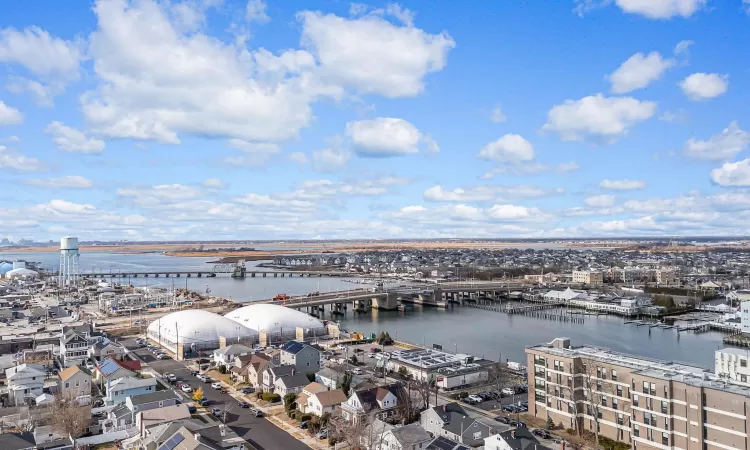 Birds eye view of property with a water view