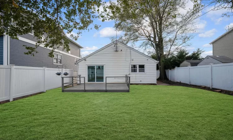 Rear view of property with a patio and a lawn