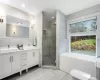 Full bathroom featuring vanity, a healthy amount of sunlight, toilet, and plus walk in shower