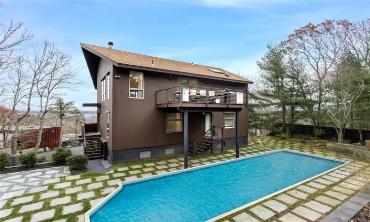 Back of house featuring a balcony