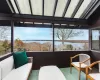 Sunroom / solarium with a water view and a healthy amount of sunlight