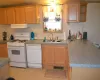 Kitchen with white appliances and sink