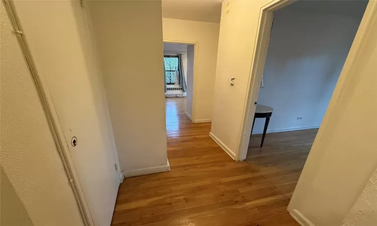 Hallway featuring  Hardwood Flooring