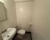 Bathroom with tile patterned flooring, toilet, and sink