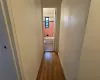 Hallway to bathroom featuring Hardwood Flooring