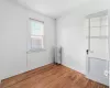 Spare room with hardwood / wood-style flooring and radiator