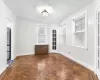 Spare room with dark parquet flooring, french doors, and a textured ceiling