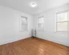 Spare room with wood-type flooring and radiator