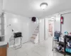 Basement featuring light tile patterned floors and sink