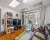 Living room featuring cooling unit, light wood-type flooring, and a textured ceiling