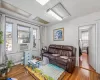 Living room featuring a textured ceiling, cooling unit, a baseboard heating unit, and hardwood / wood-style flooring