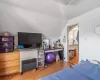 Bedroom featuring light parquet flooring and vaulted ceiling