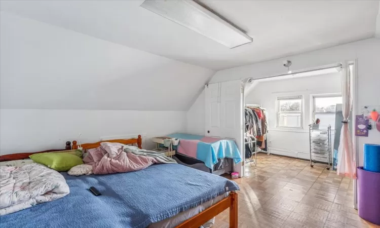 Bedroom featuring lofted ceiling