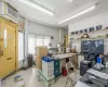 Office with a drop ceiling and an AC wall unit