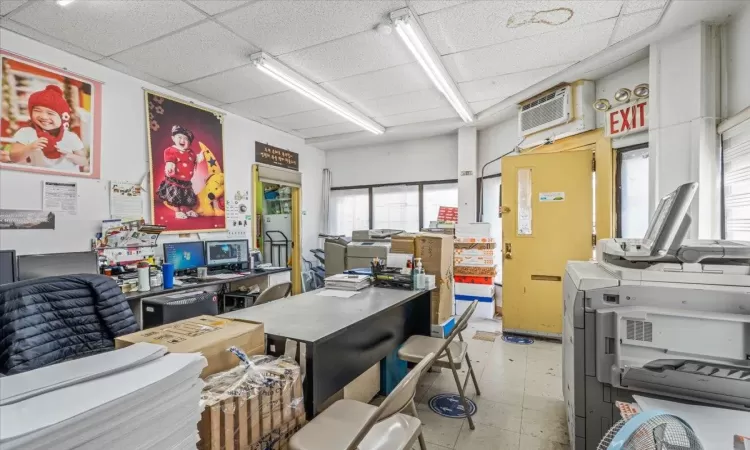 Office with a drop ceiling and a wall mounted AC