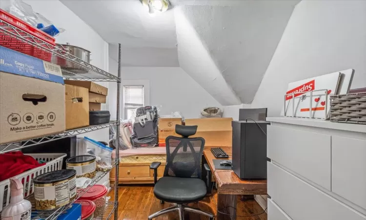 Office with hardwood / wood-style floors and vaulted ceiling