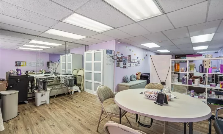 Dining space featuring a paneled ceiling and wood-type flooring