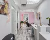 Home office with a drop ceiling and light hardwood / wood-style flooring