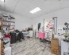 Home office with a paneled ceiling and light wood-type flooring