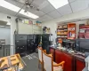 Carpeted office space featuring a drop ceiling and ceiling fan