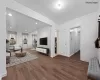 Living room featuring ornamental molding and hardwood / wood-style flooring