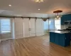 Kitchen with blue cabinetry, decorative light fixtures, a barn door, and stainless steel appliances